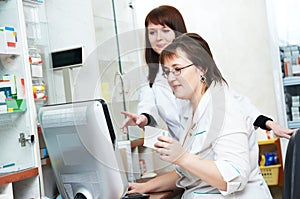 Pharmacy chemist women in drugstore with phone
