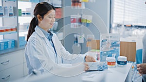 Pharmacy Drugstore Checkout Cashier Counter: Professional Asian Female Pharmacist Recommends