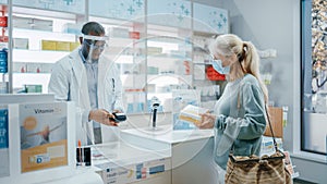 Pharmacy Drugstore Checkout Counter: Professional Black Pharmacist Wearing Face Shield Sells