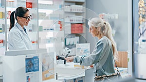 Pharmacy Drugstore Checkout Counter: Professional Female Pharmacist Sells Medicine to Diverse Group