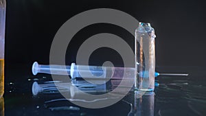 Pharmacy macro. Closeup shot of different pills falling on table with tablets cans and syringes - mosern drug and