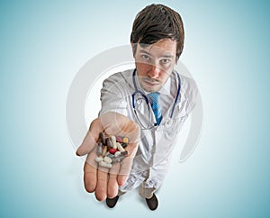 Pharmacy and Pharmacology concept. Doctor holds many pills in hand. photo