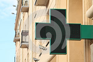 Pharmacy sign on the street. Green pharmacy sign.