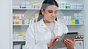 Pharmacy technology, portrait of a friendly pharmacist checking online prescriptions and orders on an app . Face of a