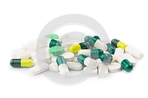 Green capsules and white antibiotic pills.