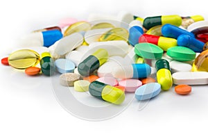 Pharmacy theme. Multicolored Isolated Pills and Capsules on the White Surface.
