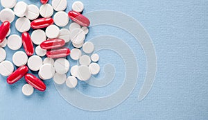 Pharmacy theme, white and red medicine tablets antibiotic pills on blue background
