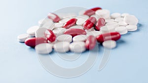 Pharmacy theme, white and red medicine tablets antibiotic pills on blue background