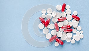 Pharmacy theme, white and red medicine tablets antibiotic pills on blue medicine background