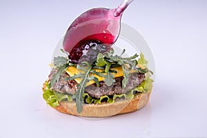 Phased assembly of a hamburger on a light background13