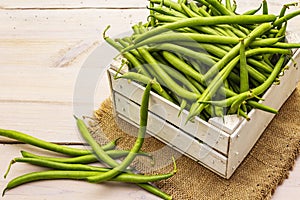 Phaseolus vulgaris, green common bean or kidney bean in wooden box