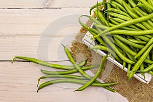 Phaseolus vulgaris, green common bean or kidney bean in wooden box