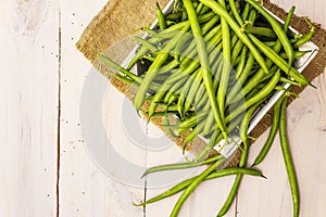 Phaseolus vulgaris, green common bean or kidney bean in wooden box