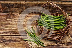 Phaseolus vulgaris, green common bean in wicker basket