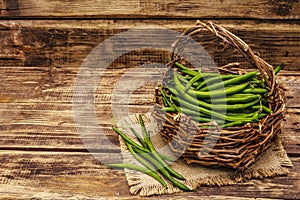 Phaseolus vulgaris, green common bean in wicker basket