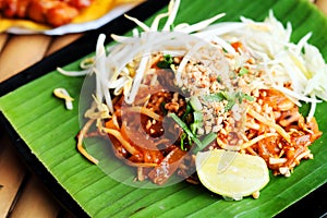 Phat thaior Pad thai is a famous Thailand tradition cuisine with fried noodle served on banana leaf