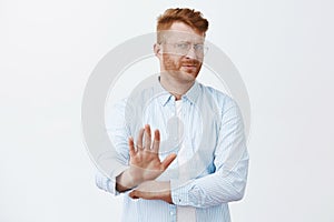 Phew, no thanks, I pass. Displeased unimpressed and uninterested handsome mature redhead man with beard, turning away photo