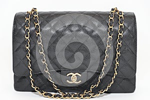 Photo of black Chanel handbag brand Editorial on white background.