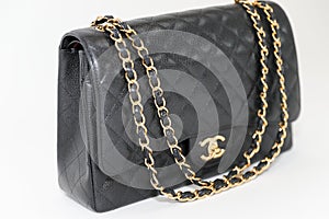 Photo of black Chanel handbag brand Editorial on white background.