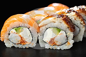 Philadelphia roll sushi with salmon, prawn, avocado, cream cheese over dark background. Sushi menu. Japanese food.