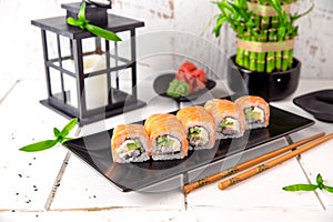 Philadelphia roll sushi with salmon, prawn, avocado, cream cheese. Sushi menu.