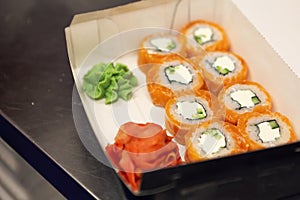 Philadelphia rolls set in boxes on the table