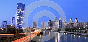 Philadelphia skyline illuminated at dusk and Schuylkill River photo