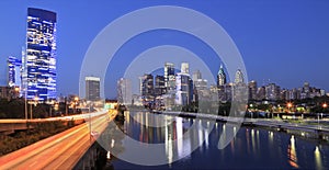 Philadelphia skyline illuminated and reflected into Schuylkill River at dusk photo