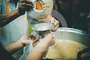 Philanthropists donate food and help the poor : concept of feeding