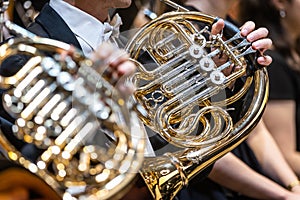 Philharmonic orchestra playing on the french horn, performance concert, classical music concept