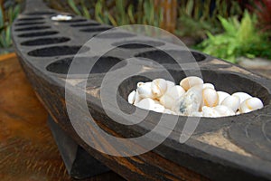 Philippine mancala sungka game consists of wooden board and seed shells