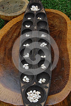 Philippine mancala sungka game consists of wooden board and seed shells