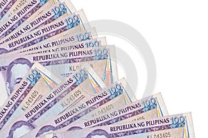 100 Philippine piso bills lies isolated on white background with copy space stacked in fan close up