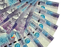 100 Philippine piso bills lies isolated on white background with copy space stacked in fan shape close up