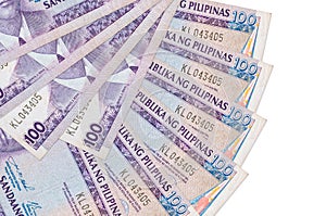 100 Philippine piso bills lies isolated on white background with copy space stacked in fan shape close up