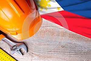 Philippines flag with different construction tools on wood background, with copy space for text