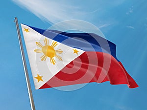 Philippines flag on a pole waving. Philippines realistic flag waving against clean blue sky.