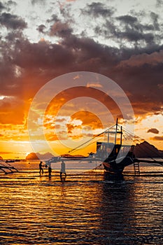 Philippines. Local boat`s silhouette at the bay. Sunset sky.