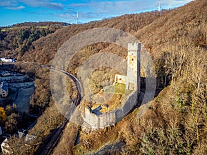 Philippsburg castle ruins with castle tower near Monreal in sunshine and a blue sky