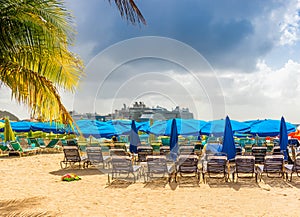 Philipsburg beach and its blue umbrellas and cruise ships on the island of Saint Martin in the Caribbean