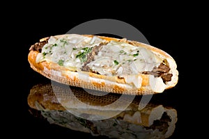 PHILLY CHEESE STEAK with reflection  on black background