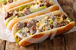 Philly cheese steak sandwich served on parchment paper close-up. Horizontal