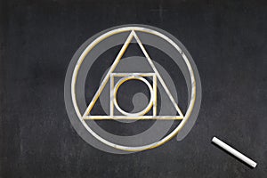 Philosopher\'s stone symbol drawn on a blackboard