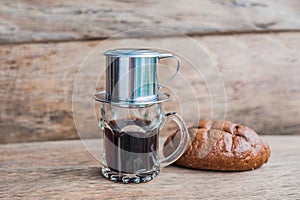 `Phin` traditional Vietnamese coffee maker, place on the top of glass, add ground coffee then pour hot water and wait