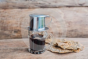`Phin` traditional Vietnamese coffee maker, place on the top of glass, add ground coffee then pour hot water and wait