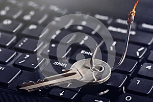 Phishing, hacking personal data, money , key and hook on computer keyboard