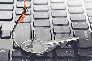 Phishing, hacking personal data and money , key and hook on computer keyboard