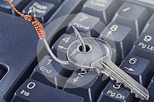 Phishing, hacking personal data and money , key and hook on computer keyboard