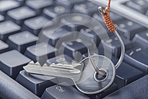 Phishing, hacking personal data and money , key and hook on computer keyboard