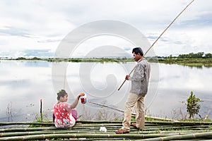 Image of lake in Asia , couple portrait. Fisherman in lake. Traditional countryside  in rural part of Cambodia